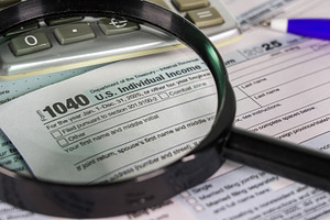 Tax form and calculator with a magni, a Photo by 1miromiro