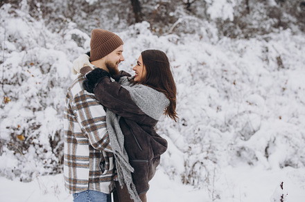 Portrait of a young happy and loving couple having fun in a snow, a Person Photo by Cherkas Photography