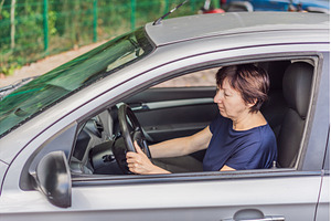 Older woman driving a car with focus, a Transportation Photo by Elizaveta Galitskaya