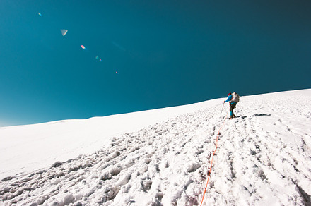 Man climbing to mountain summit stock photo containing outdoor and hiking, a Sports & Recreation Photo by e v e r s t