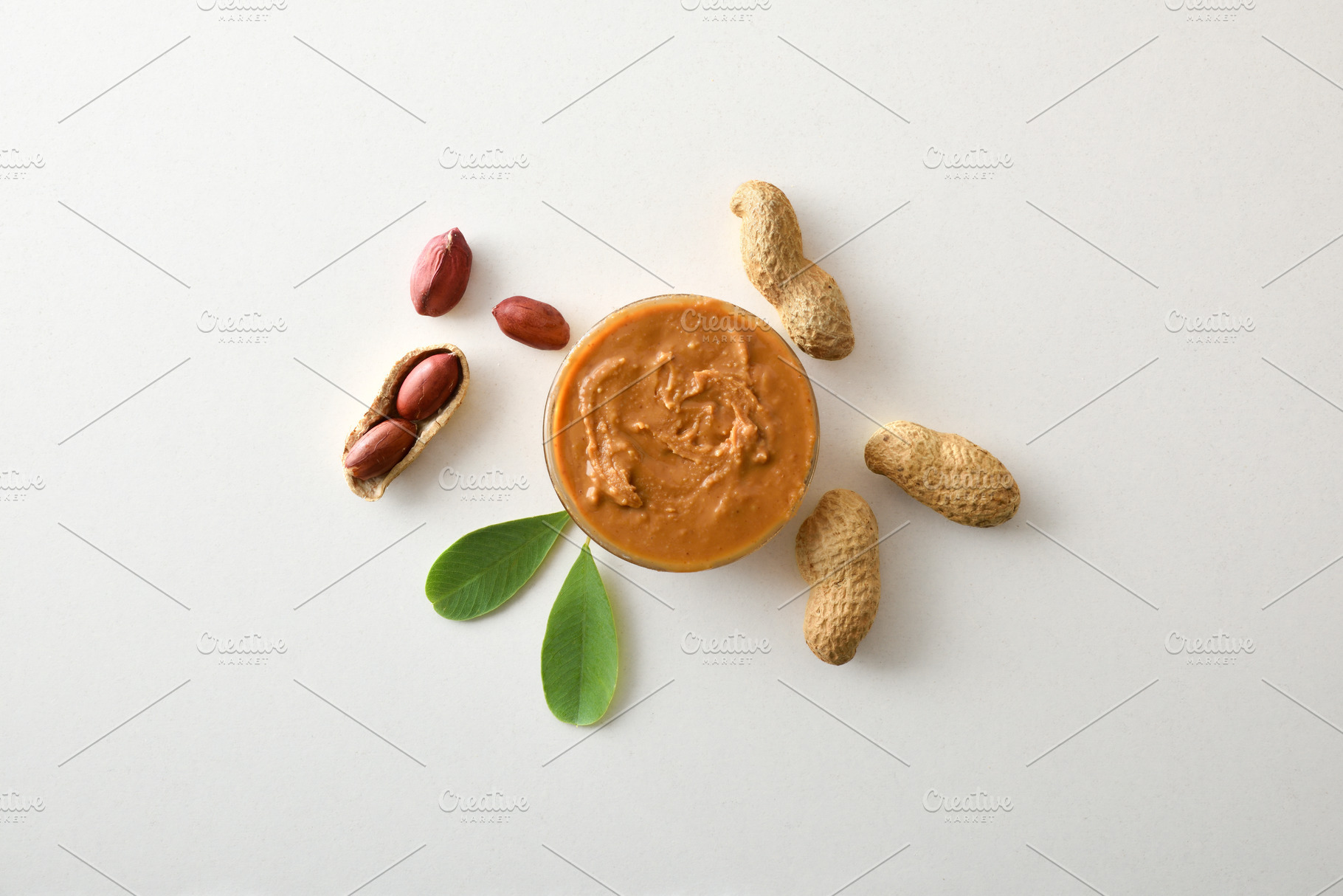 Peanut butter in a bowl and peanuts in the center, a Food & Drink Photo by Davizro's Market