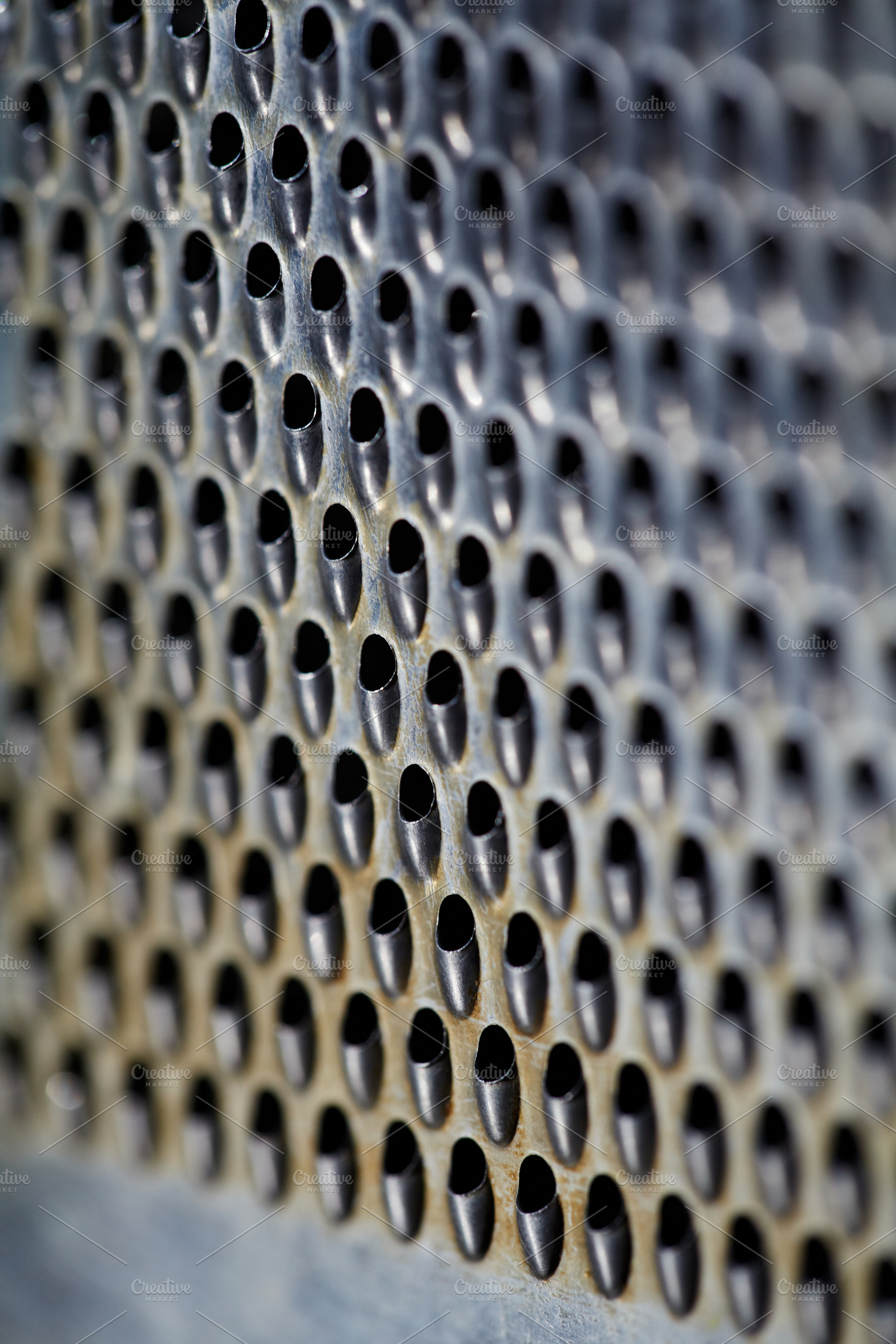 Macro texture of a stainless steel grater with small perforated holes. Abstract, a Background Photo by Rohan Photography