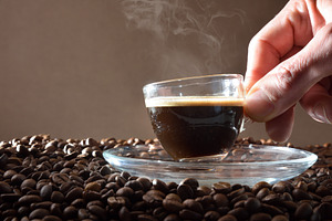 Hand holding glass cup with hot coffee for tasting, a Food & Drink Photo by Davizro's Market