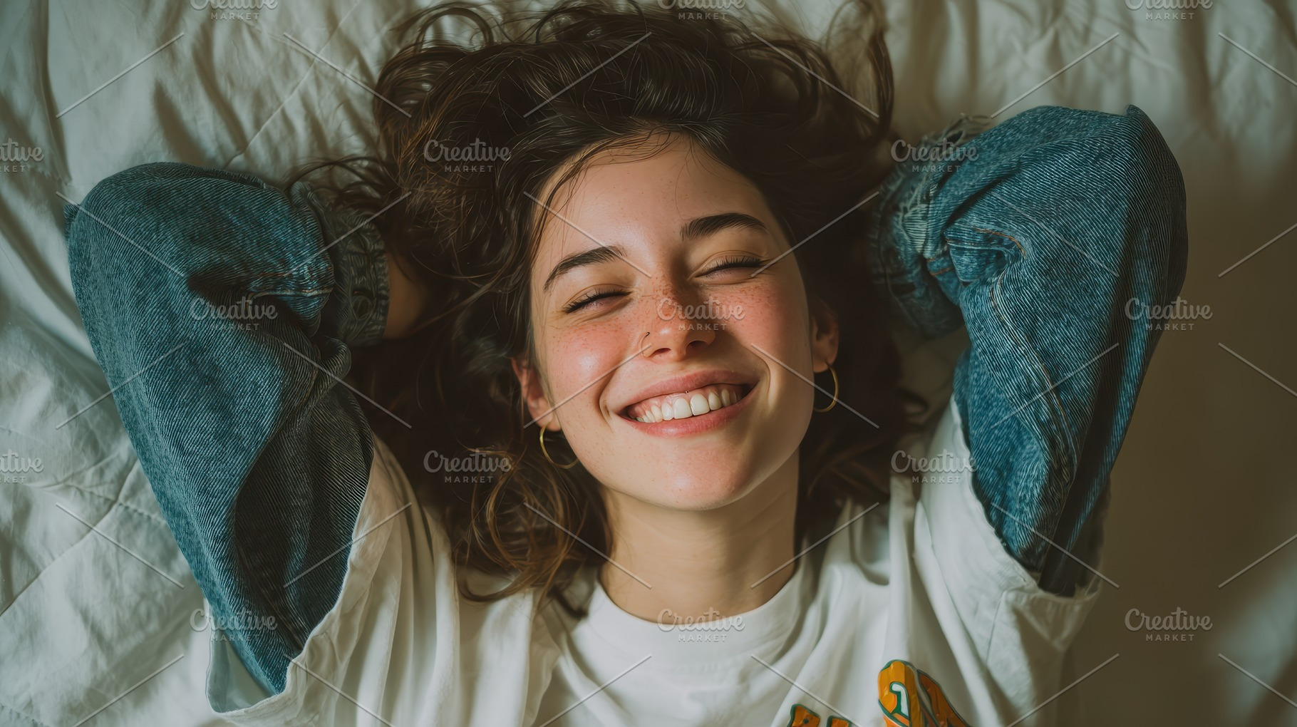 Happy woman in bed smiling carefree, a Photo by Pixeness Studio