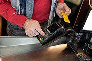 Unrecognizable male customer paying with credit card, a Photo by Prostock-Studio (Thumbnail 2 of 2)