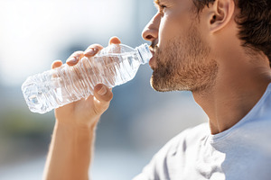 Man drinking water from a bottle, a Food & Drink Photo by MistyDay