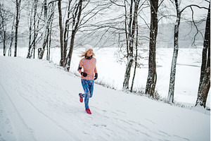 Active elderly woman jogging in cold, a Sports & Recreation Photo by HalfPoint