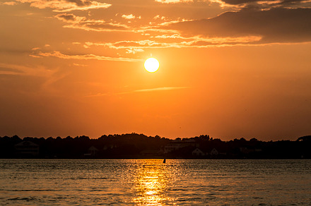 Ocean city containing sunrise, surfer, and surfers