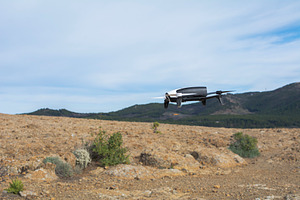 Drone flying containing landscape, desert, and sky