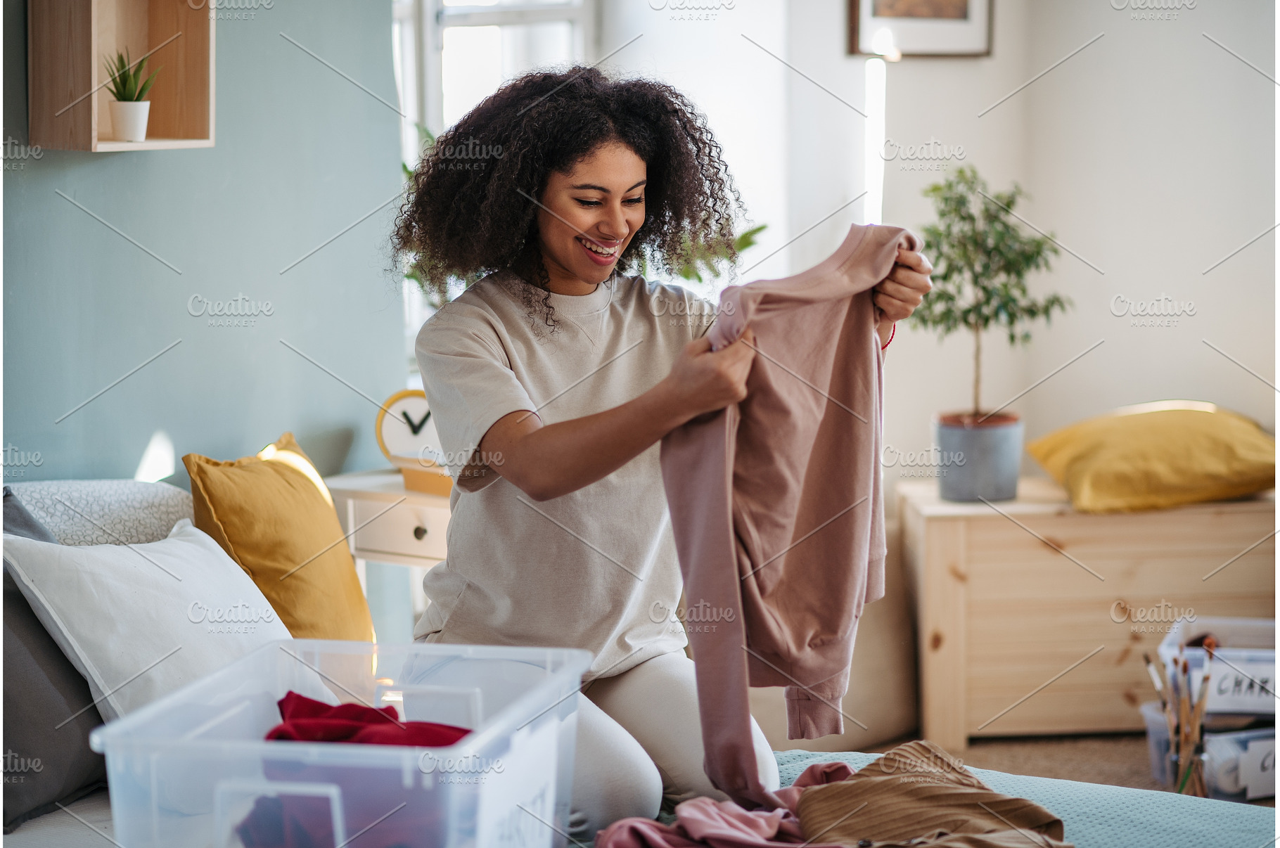Young woman sorting wardrobe indoors, a Person Photo by HalfPoint