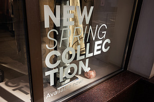 Window display featuring new clothing collection promoting spring fashion trend, a Photo by AS photostudio
