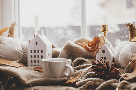 Autumn still life. Warm cup of tea, cozy pumpkin pillows, fall l, a Holiday Photo by Sonjachni