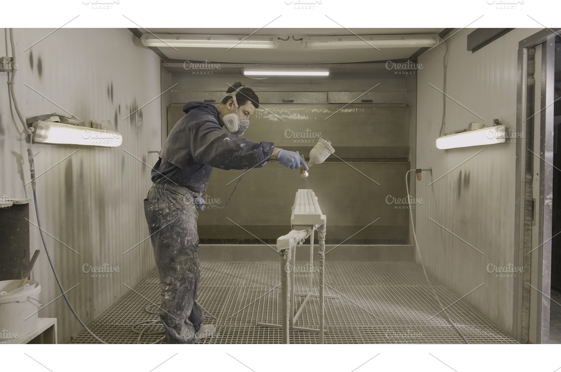 Man paints wooden beam with spray, an Industrial Photo by Media Whale Stock