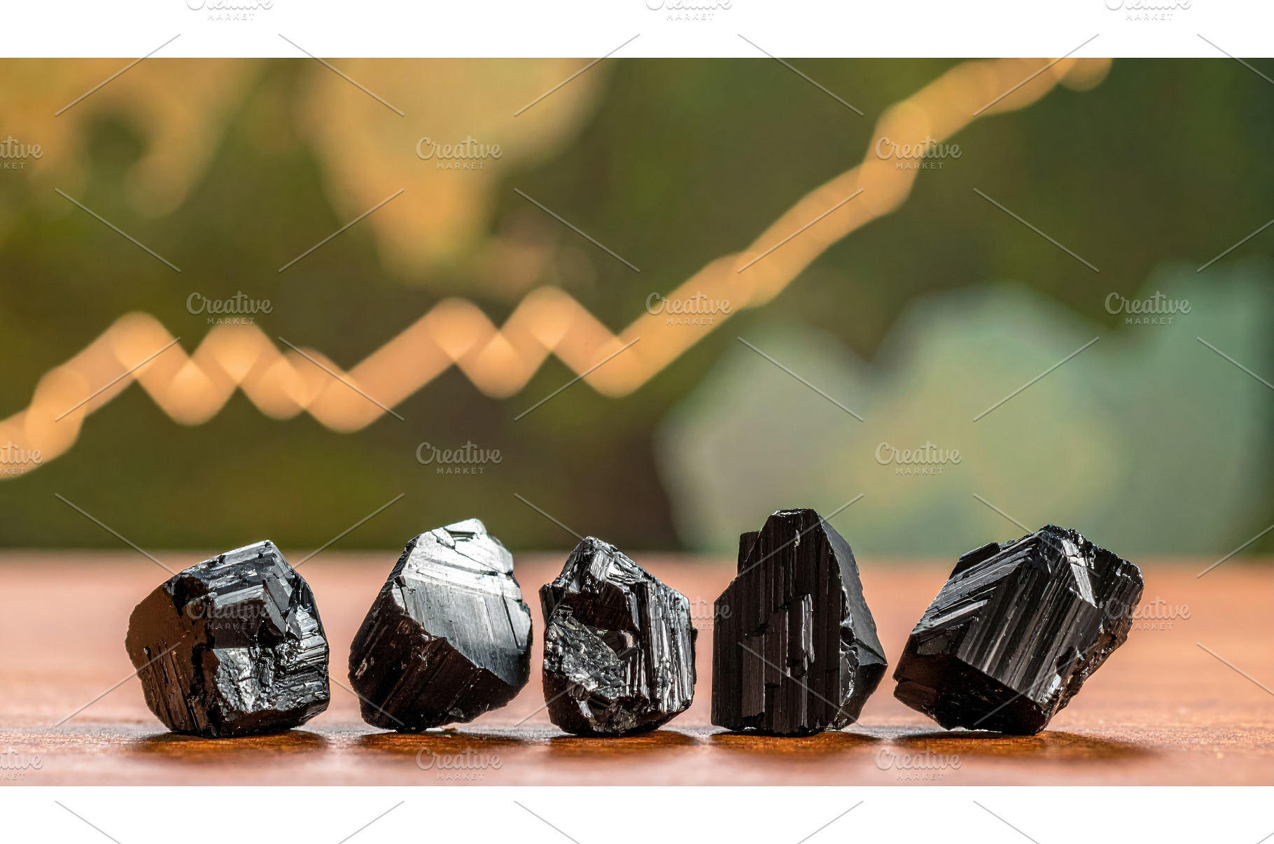 Five black stones aligned on wooden, a Business Photo by Igor Tichonow