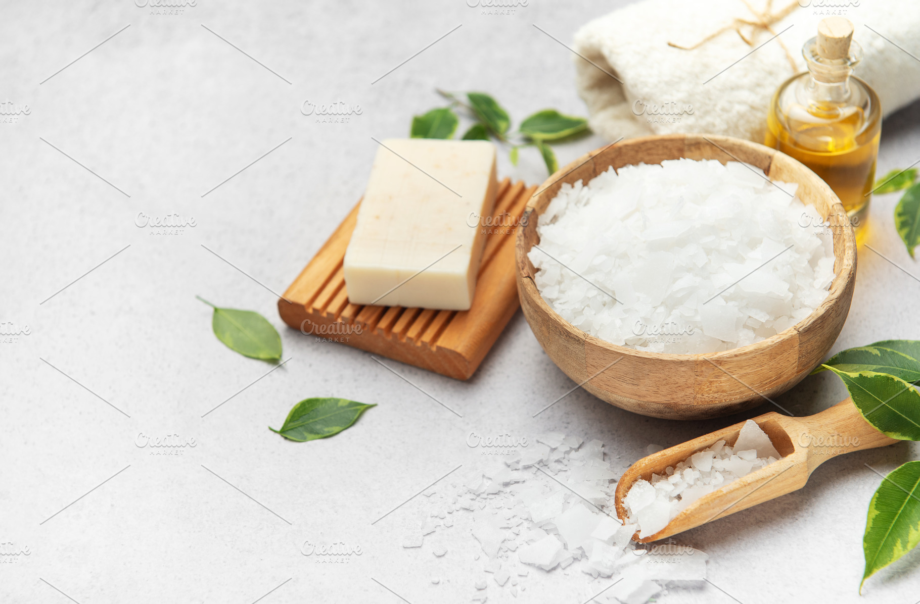 Magnesium flakes in a wooden bowl with soap, towel and essential, a Health & Medical Photo by Olena Rudo