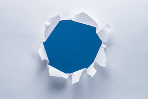 Hole on a paper. Blue background in the hole., a Background Photo by Volff
