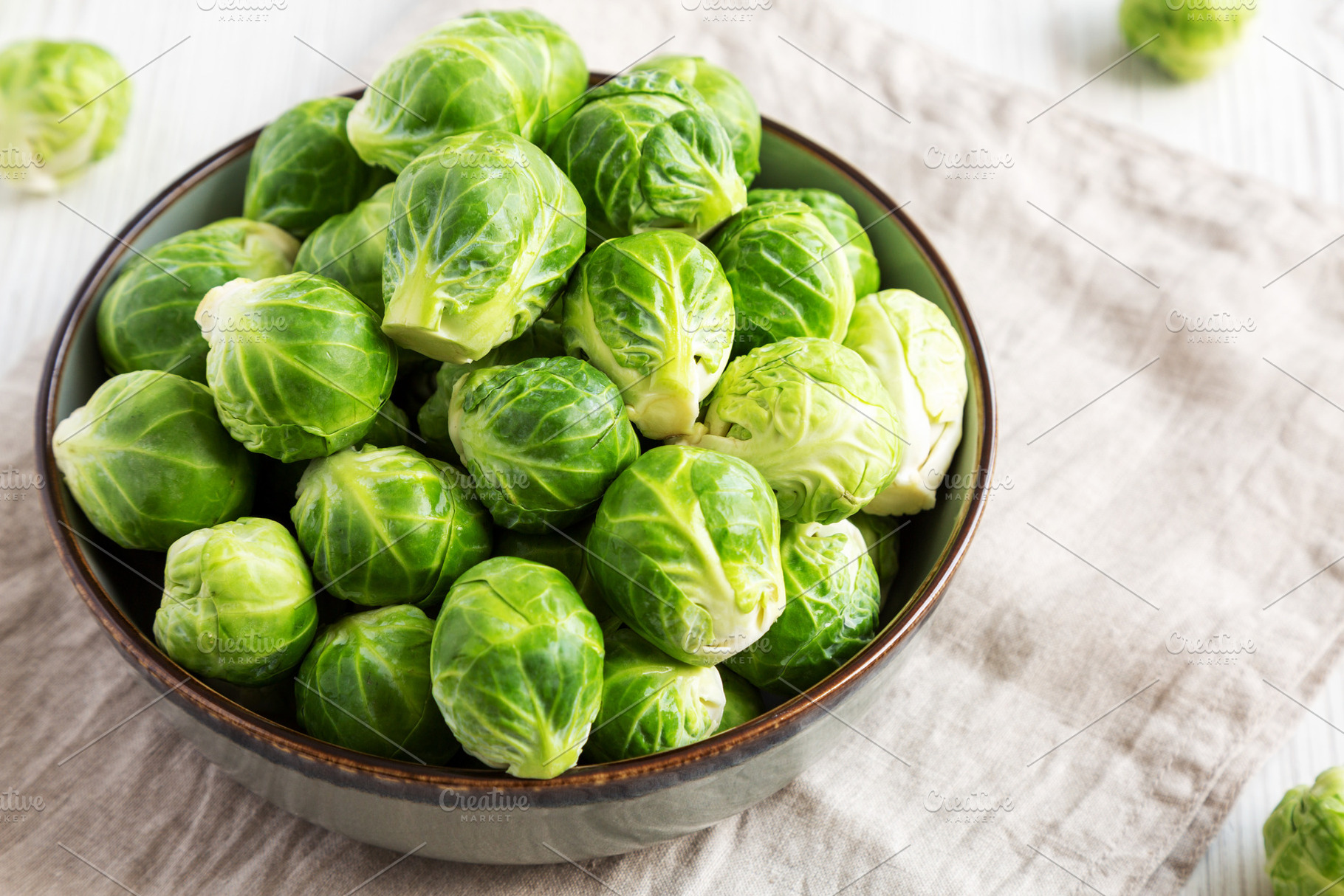 Raw Organic Brussel Sprouts in a Bowl, low angle view., a Food & Drink Photo by LiudmylaChuhunova