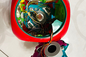 Interior view of a disassembled robotic device with colorful wiring and compone, a Photo by AS photostudio