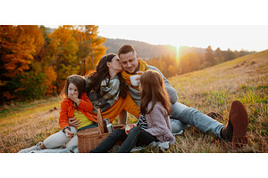 Parents with young children sitting, a Person Photo by HalfPoint