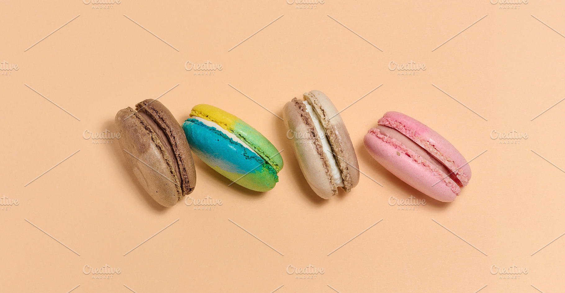 Multicolored macarons on a beige background, top view, a Food & Drink Photo by ndanko