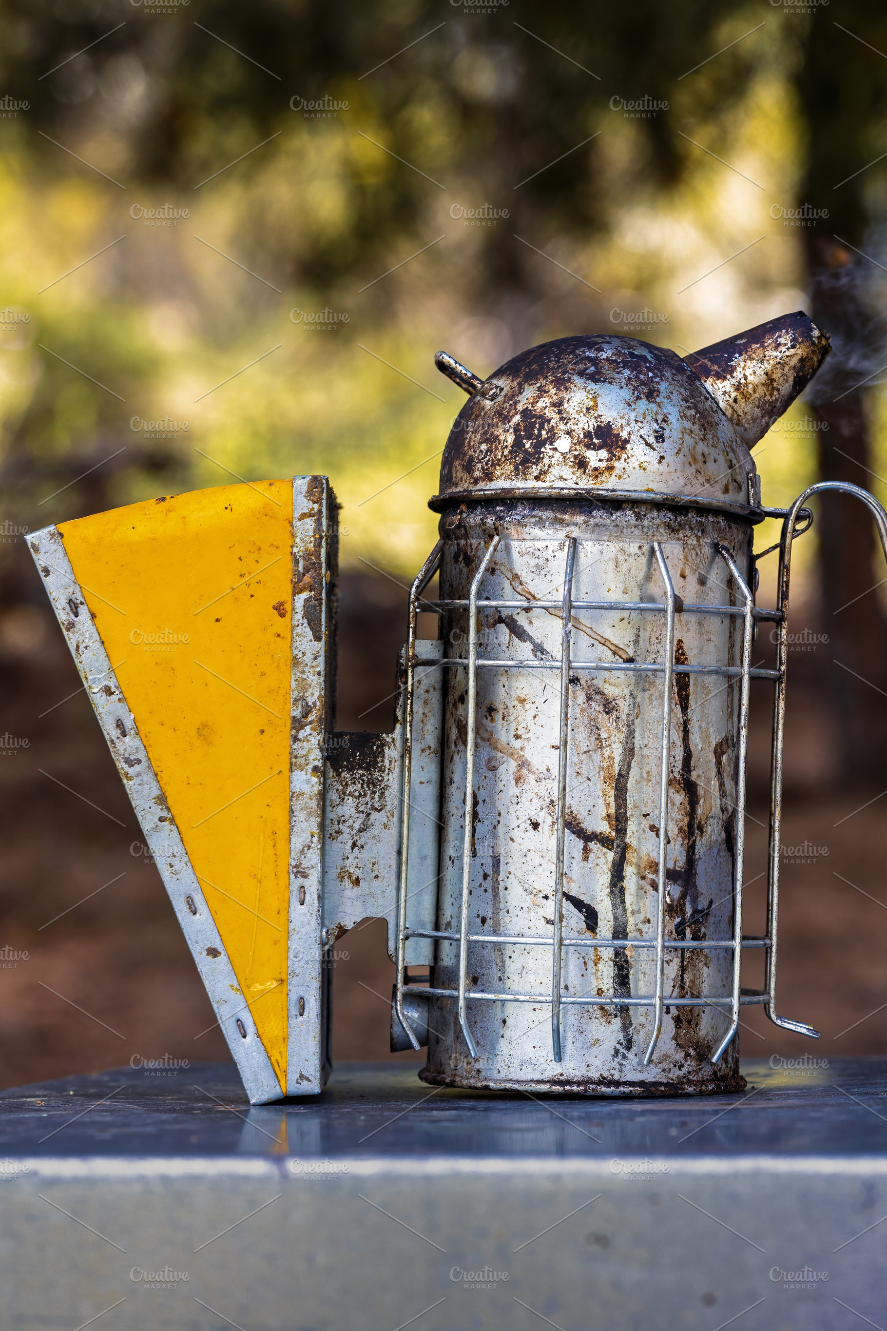 Rustic metal beekeeping smoker on a, an Industrial Photo by Perpis