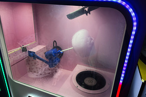 Cotton candy machine with colorful display and twirling sugar on a stick, a Photo by AS photostudio