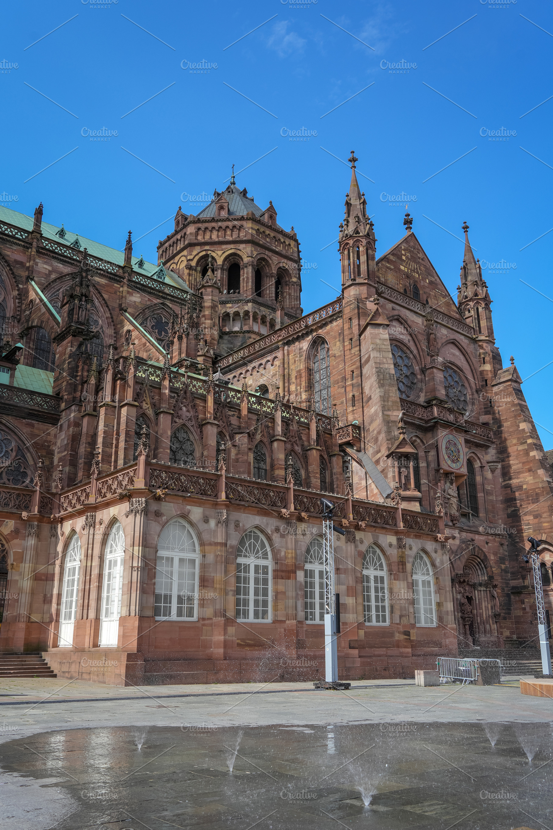 Strasbourg Cathedral and water reflections on the square, an Architecture Photo by GoodGoods