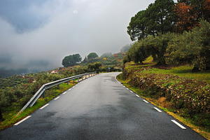 Rural paved road between green hills, a Transportation Photo by Perpis