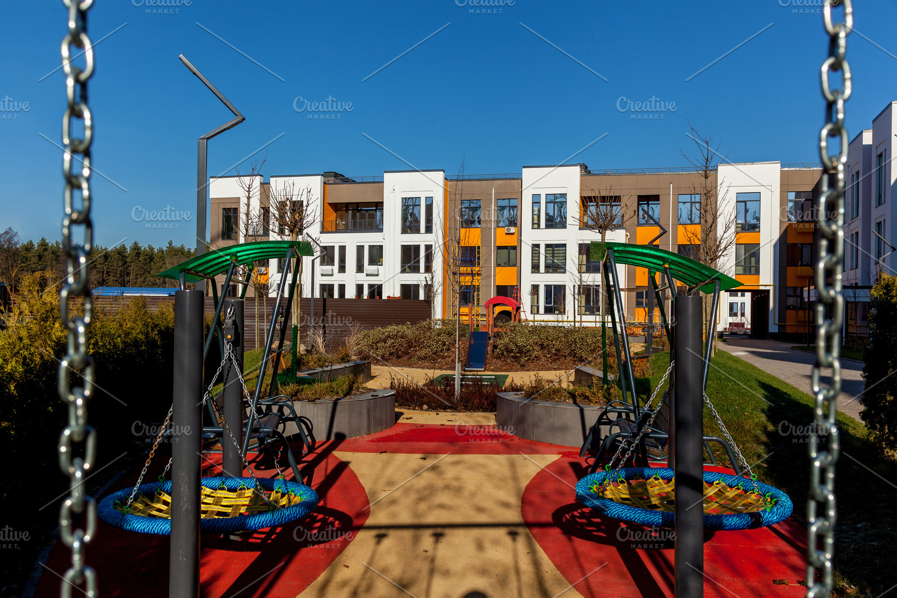 Modern playground in residential complex courtyard, an Industrial Photo by Photostock