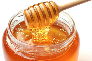 Golden honey dripping from a wooden dipper into a clear glass ja, a Photo by Studio ANNA