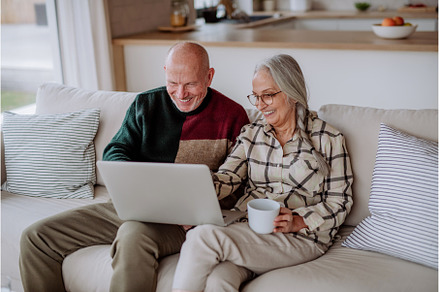 Senior couple sitting on sofa and, a Person Photo by HalfPoint