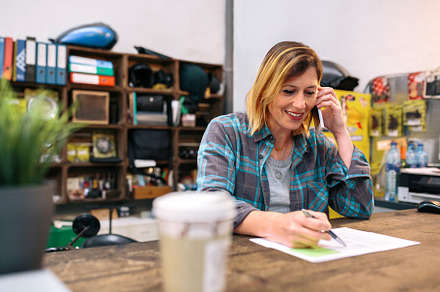 Portrait of smiling blonde young woman receiving order by phone for ecommerce s, a Person Photo by davidpereiras
