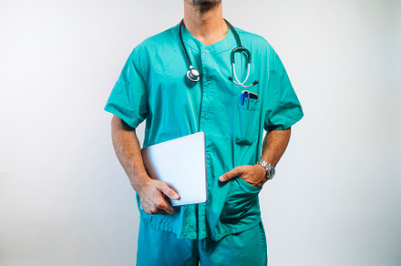 Doctor Holding Laptop in One Hand