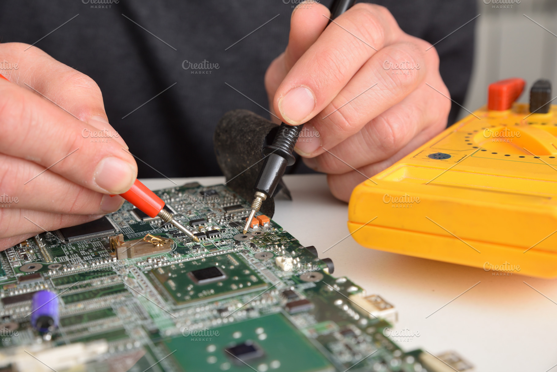 Man testing printed circuit board with multimeter, a Technology Photo by Davizro's Market