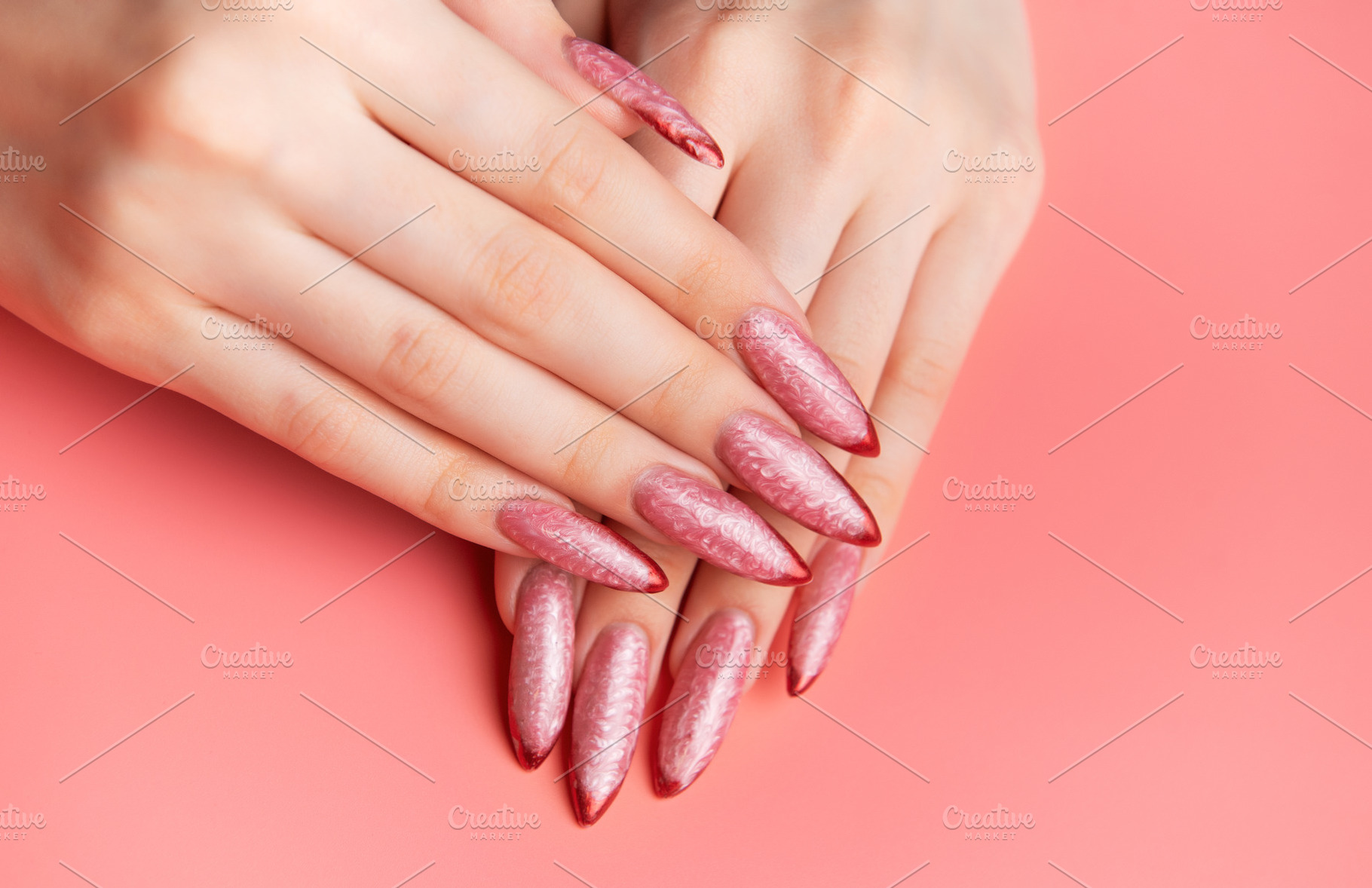 Woman's hands showing long pink almond nails with red tips, a Beauty & Fashion Photo by Olena Rudo