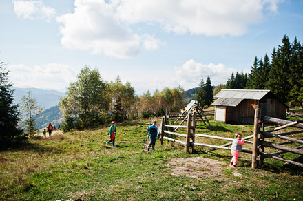 Family on a trekking day in the mountains. Ancient wooden cheese, a Person Photo by AS photostudio