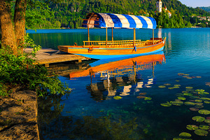 Anchored boat at the wooden pier, a Transportation Photo by Alpine Dreams