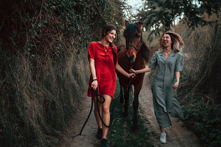 Two women friends chatting and stock photo containing women and ride, a Person Photo by Manu Reyes
