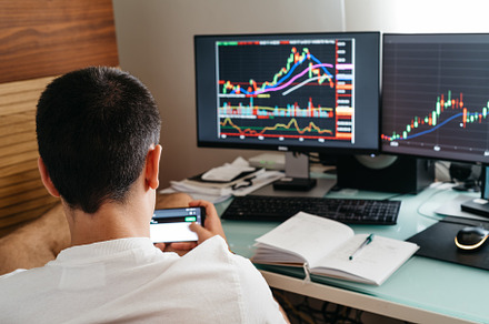 Successful young trader in casual wear working with charts and market reports a, a Person Photo by Architect´s eye