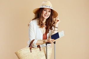 happy elegant woman in blouse and shorts against beige, a Person Photo by Alliance Images