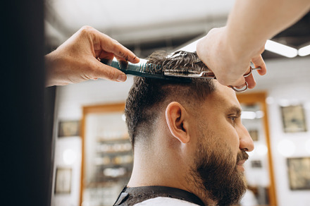 Man getting haircut at the barbershop. Professional barber at work process. Bea, a Person Photo by Volodymyr Melnyk
