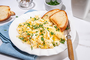 Traditional breakfast scrambled eggs with toasted bread, a Food & Drink Photo by Rimma