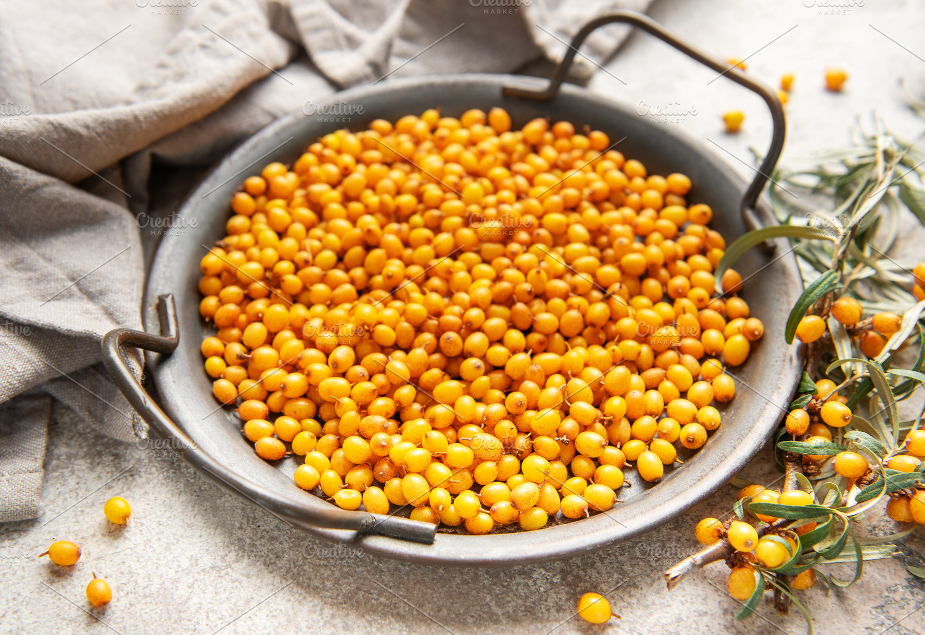 Sea buckthorn berries in bowl with branches, healthy superfood, a Food & Drink Photo by Olena Rudo