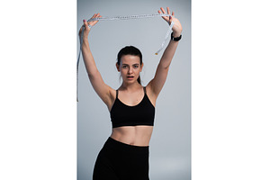 Woman in sportswear holding a tape, a Sports & Recreation Photo by volodymyrshtun13795