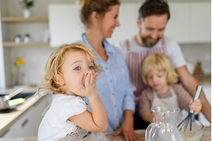 Young nuclear family making pancakes, a Person Photo by HalfPoint