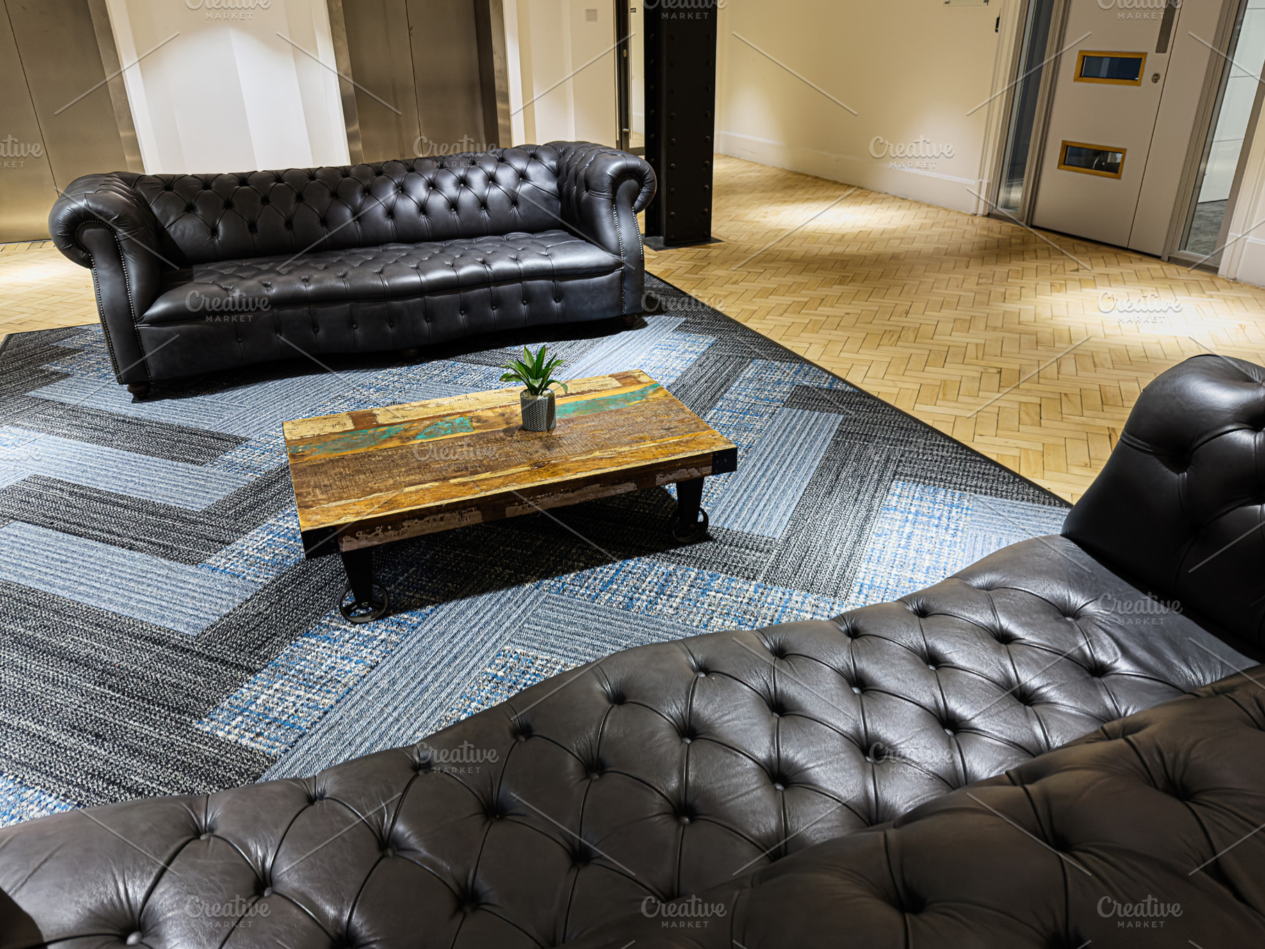 Cozy leather lounge in a modern Manchester lobby with a coffee table and a plan, a Photo by AS photostudio