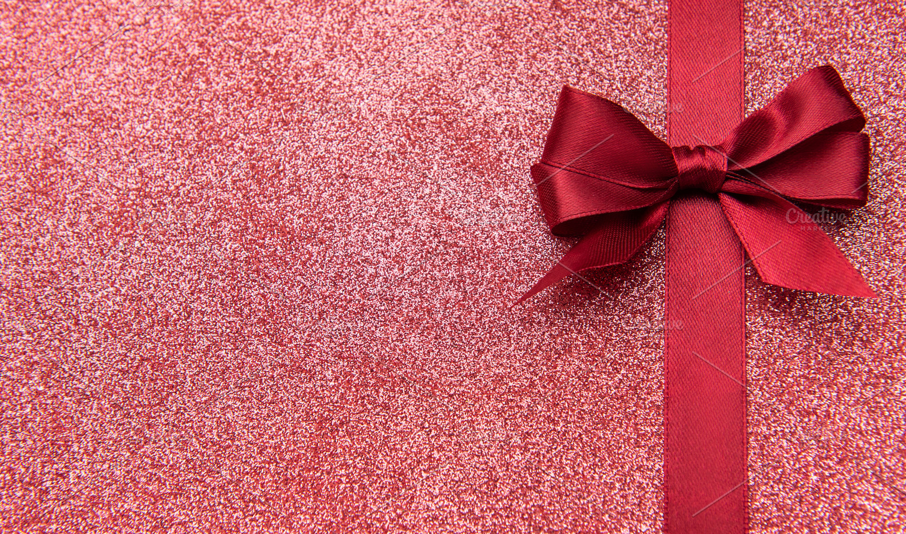 Red glitter background with ribbon bow wrapping concept, a Holiday Photo by Olena Rudo
