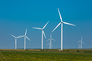 Wind turbines generating renewable energy on a grassy plain under a clear blue, a Technology Photo by Ales Munt