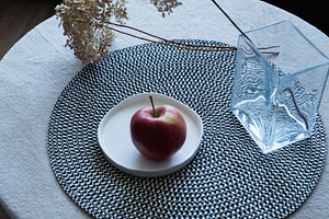 Red apple on ceramic plate on table, an Industrial Photo by MDBildes