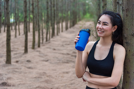 Beauty Asian sport woman resting and holding drinking water bott, a Sports & Recreation Photo by Ministocker